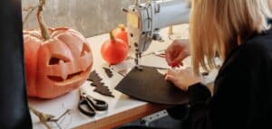 Blonde women sowing halloween crafts